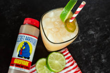 Load image into Gallery viewer, Cocktail with lime and straw next to a bottle labeled 'Secret Aardvark' on a dark background