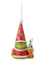 Load image into Gallery viewer, Christmas ornament featuring a green creature with a red hat and a dog, on a white background