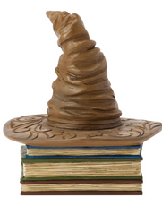 Load image into Gallery viewer, Figurine of a Sorting Hat from Harry Potter on top of books with decorative elements on a white background. Artist Jim Shore.