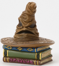 Load image into Gallery viewer, Figurine of a Sorting Hat from Harry Potter on top of books with decorative elements on a white background. Artist Jim Shore.