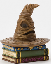 Load image into Gallery viewer, Figurine of a Sorting Hat from Harry Potter on top of books with decorative elements on a white background. Artist Jim Shore.