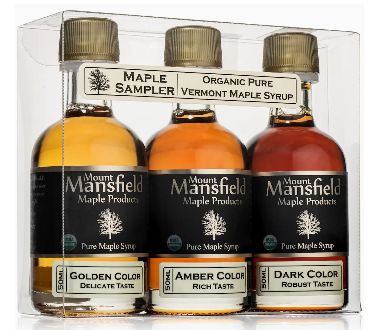 Three bottles of Mount Mansfield Maple Products maple syrup in a clear packaging box.