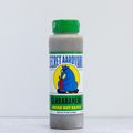 Secret Aardvark Serrabanero Green Hot Sauce bottle on a light gray background