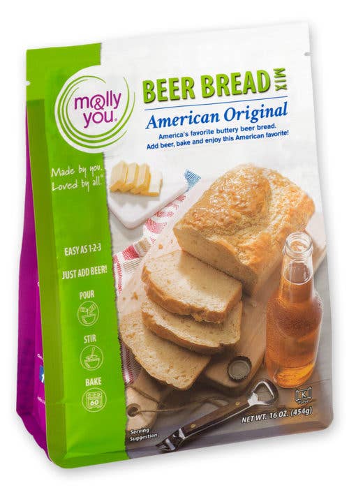 Package of Molly You Beer Bread mix with bread slices and beer bottle on a white background