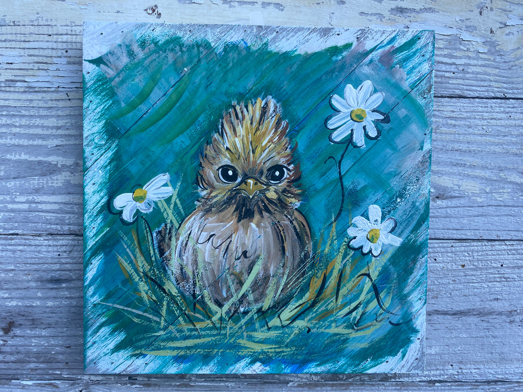 Painting of a bird surrounded by flowers on a textured surface