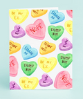 Card with colorful heart-shaped candy言论 on a light blue background