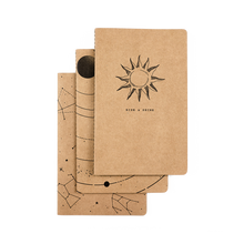 Load image into Gallery viewer, Set of three kraft paper notebooks with celestial designs on a white background
