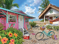 Tropical beach scene with colorful houses, a bicycle, and beach accessories.
