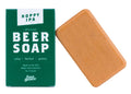 Hoppy IPA Beer Soap by Swag Brewery, featuring a green cardboard box with white text next to a rectangular bar of orange-brown soap on a white background.