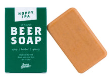 Load image into Gallery viewer, Hoppy IPA Beer Soap by Swag Brewery, featuring a green cardboard box with white text next to a rectangular bar of orange-brown soap on a white background.
