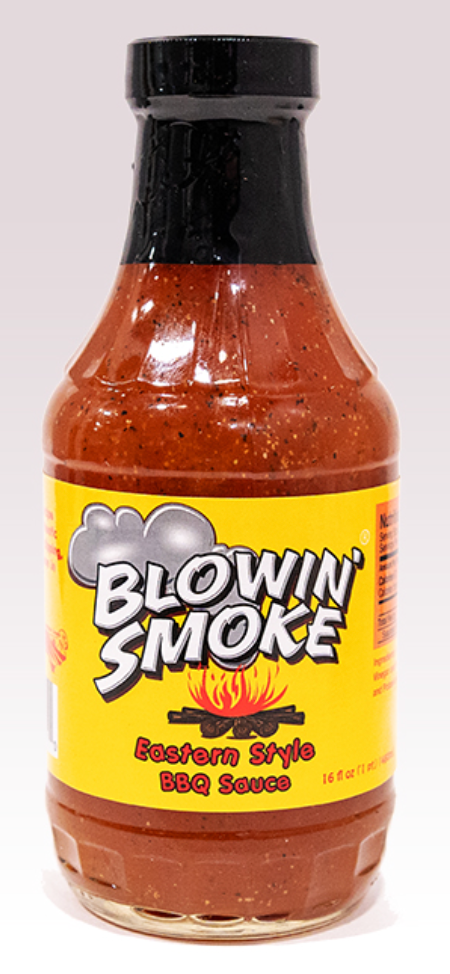 A bottle of Blowin' Smoke Eastern Style BBQ Sauce with a bright yellow label and black cap, filled with reddish-brown sauce, on a light gray background.