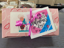 Load image into Gallery viewer, Valentine's Day themed gift box with a card featuring a cartoon character and decorative ribbons.
