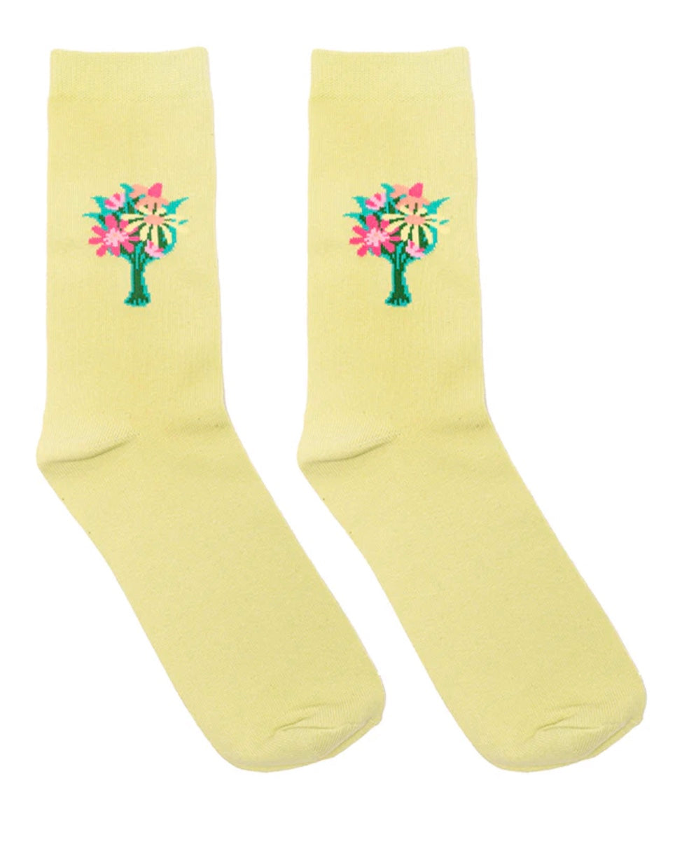 Pair of yellow socks with floral designs on a white background