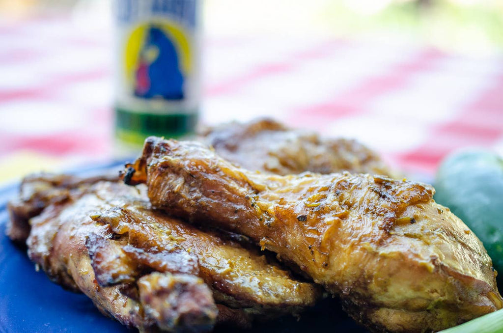 Baked chicken wings on a blue plate with a blurred background