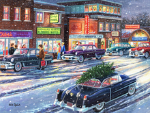 Load image into Gallery viewer, Vintage car with a Christmas tree on a snowy street scene with classic buildings.
