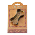 Dog biscuit in a bone-shaped cookie cutter on a branded packaging