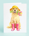 Illustration of a dog wearing a yellow hat and pink rain boots holding tulips on a light blue background