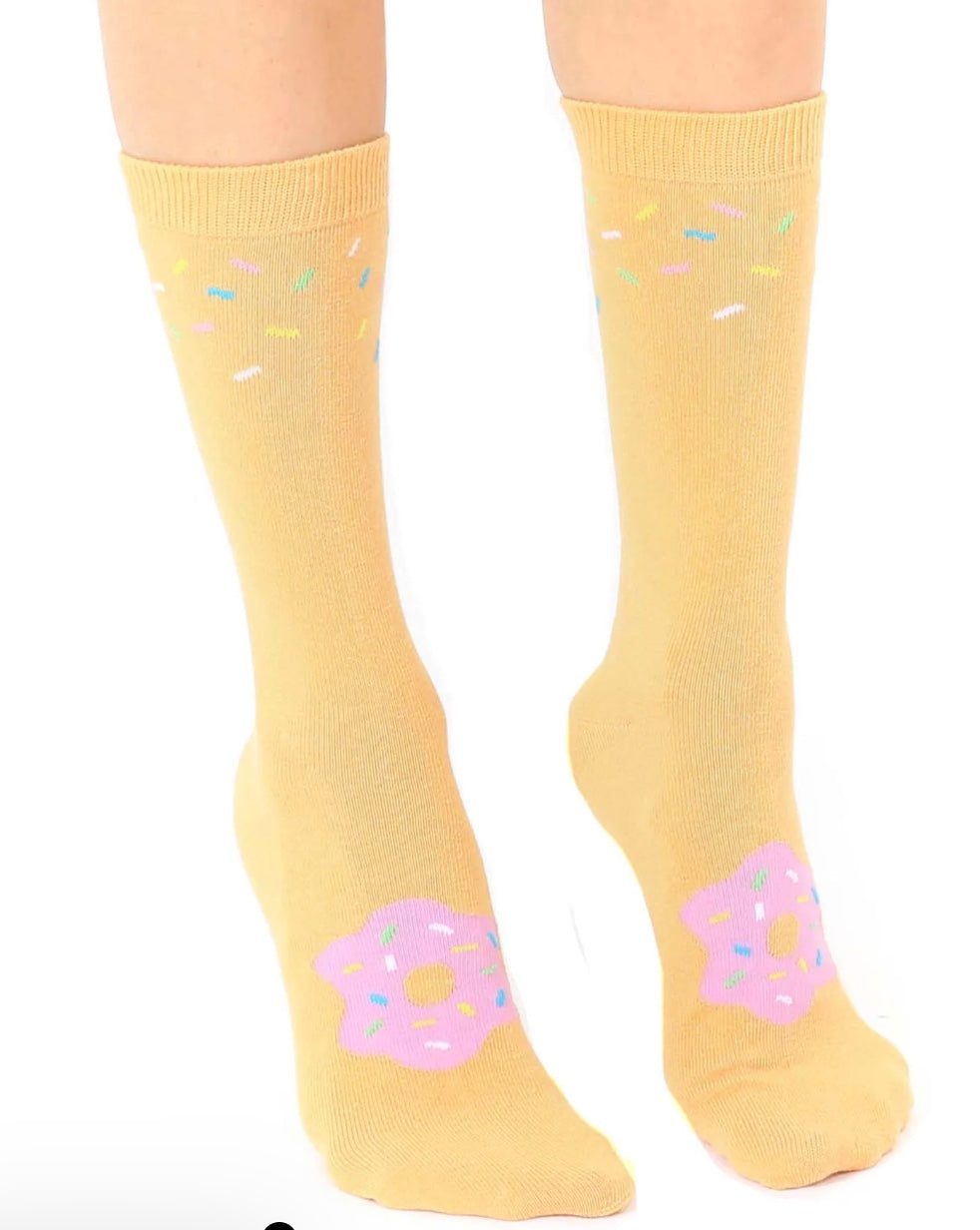 Yellow socks with pink donut designs on a white background
