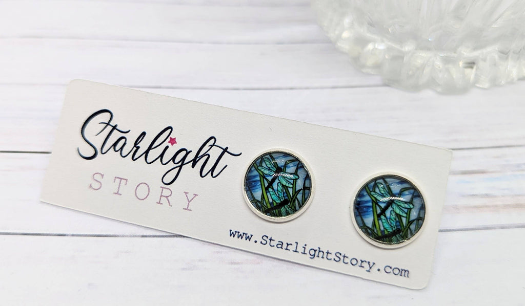Pair of dragonfly-themed earrings on a 'Starlight Story' branded card with a white background.