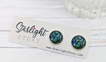 Load image into Gallery viewer, Pair of dragonfly-themed earrings on a 'Starlight Story' branded card with a white background.
