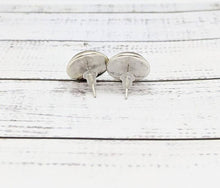 Load image into Gallery viewer, Pair of silver stud earrings on a white wooden surface
