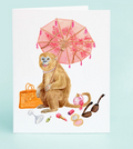Card with a monkey holding a pink umbrella, surrounded by accessories on a light blue background

Details