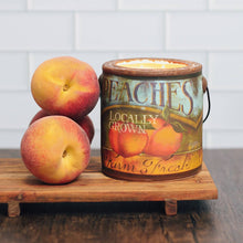Load image into Gallery viewer, Peaches next to a peach-themed candle on a wooden surface with a white tiled wall background.
