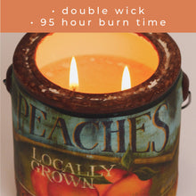 Load image into Gallery viewer, Candle with 'Peaches Locally Grown' label and two wicks burning.

