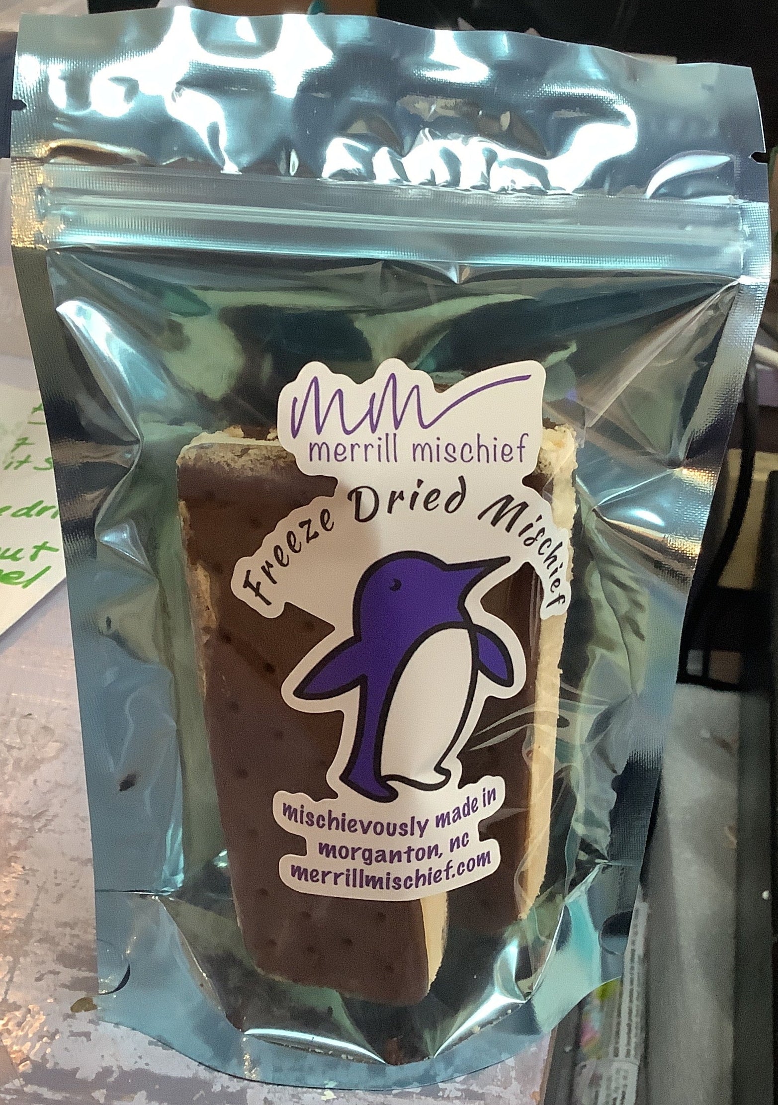 Merril Mischief freeze-dried meal pouch on a desk with office items in the background