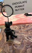 Load image into Gallery viewer, A close-up of a chocolate peanut butter spread surface with a small black cat-shaped table clip holding a sign that reads 'CHOCOLATE PEANUT BUTTER.'.
