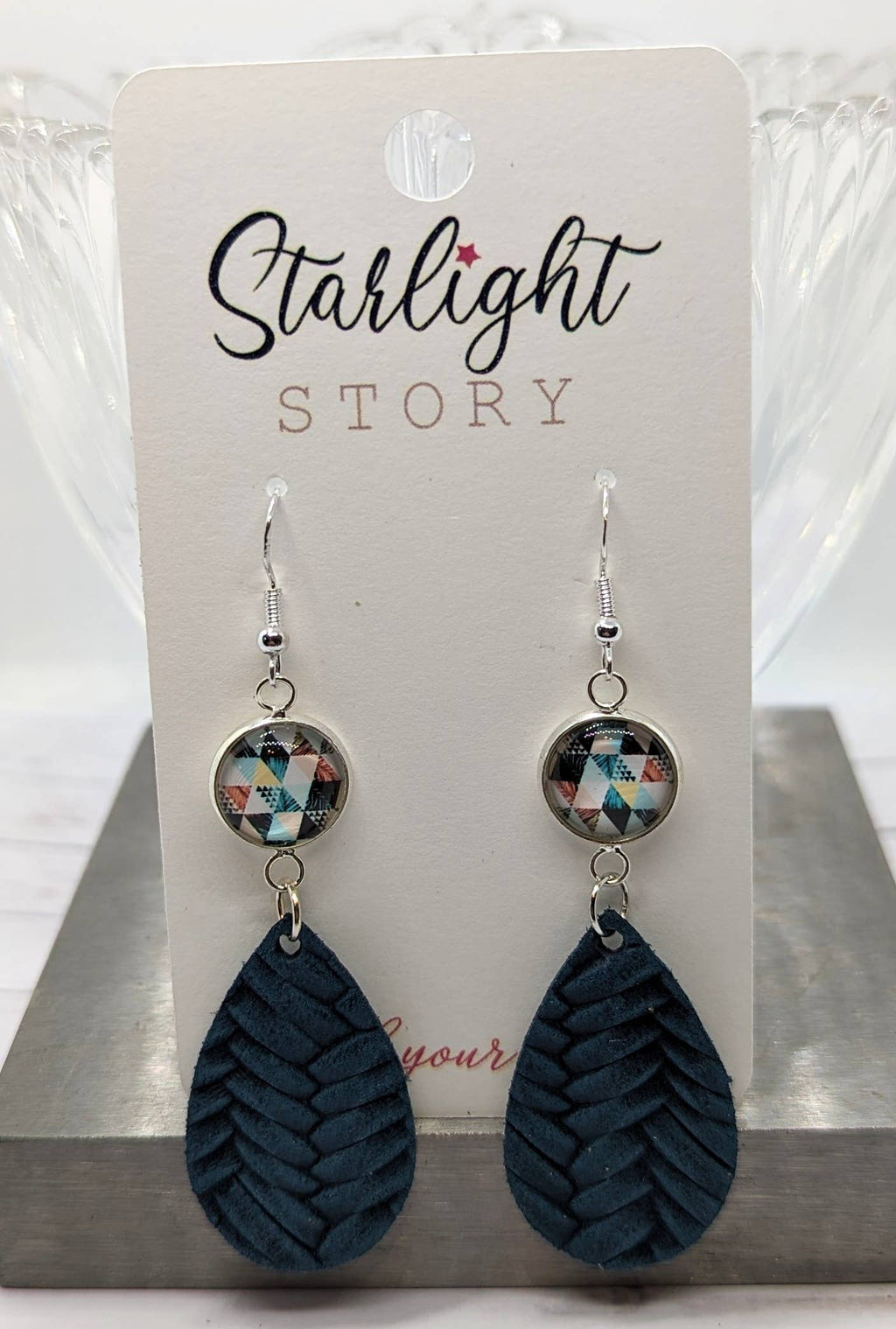 Pair of earrings on a 'Starlight Story' branded card.