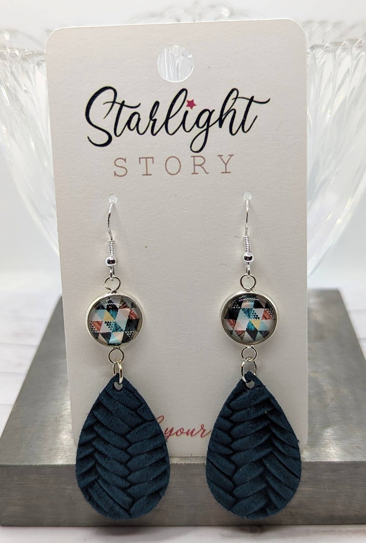 Pair of earrings on a 'Starlight Story' branded card.