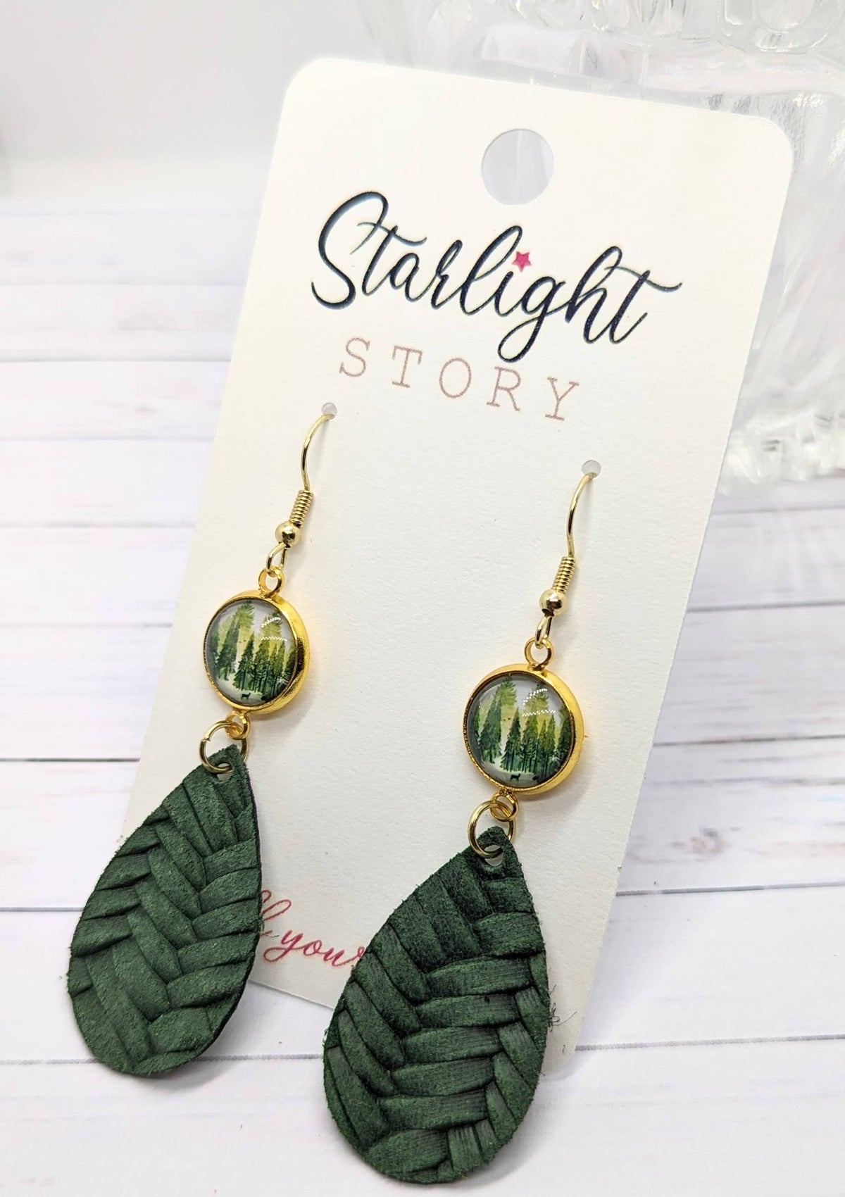 Green woven teardrop earrings on a 'Starlight Story' branded card.