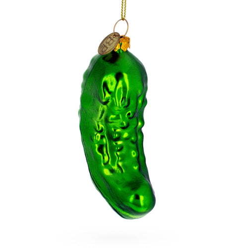 Green glass pickle ornament on a white background