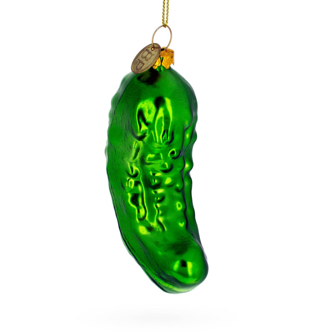 Green glass pickle ornament on a white background