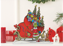 Load image into Gallery viewer, Illustration of the Grinch with a sleigh full of presents and a dog in a Christmas scene.
