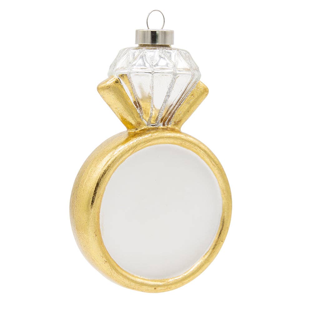 Gold ring-shaped ornament with a clear gemstone on a white background