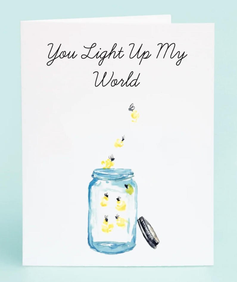 Card with a jar of candles and text 'You Light Up My World' on a light blue background