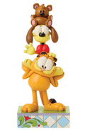 Stacked figurines of a bear, dog, and cat on a decorative base with a white background
