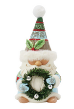 Load image into Gallery viewer, Decorative gnome figure with a wreath and festive hat on a white background

