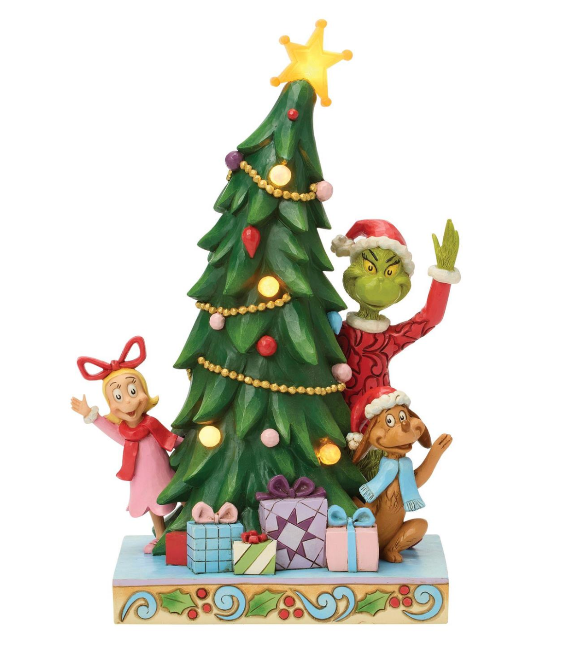 Figurine of a Grinch-like character with a Christmas tree and presents on a white background