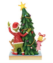 Load image into Gallery viewer, Decorative figurine of a character with a reindeer and a child next to a Christmas tree on a white background
