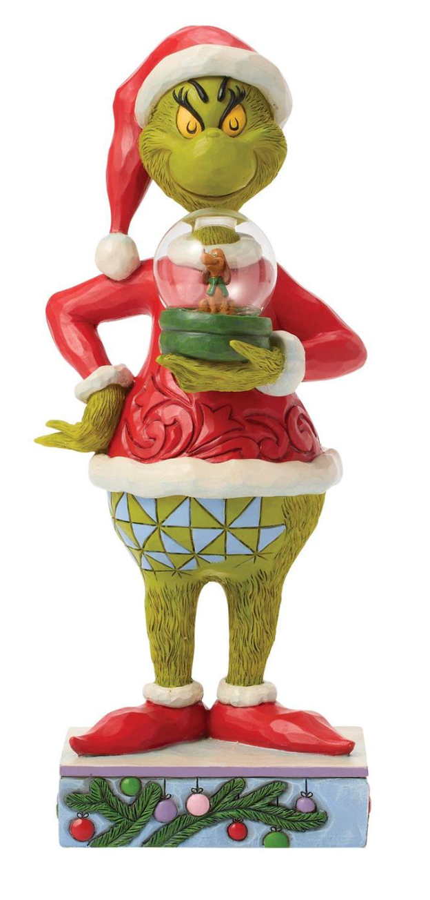 Statue of a character in a Santa hat holding a snow globe with a small figure inside, on a white background.