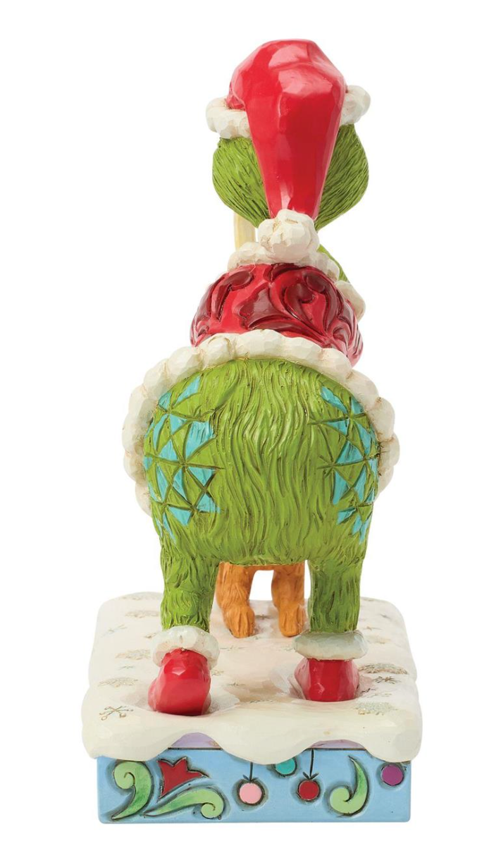 Decorative figurine of a character with a red hat and green body on a white background