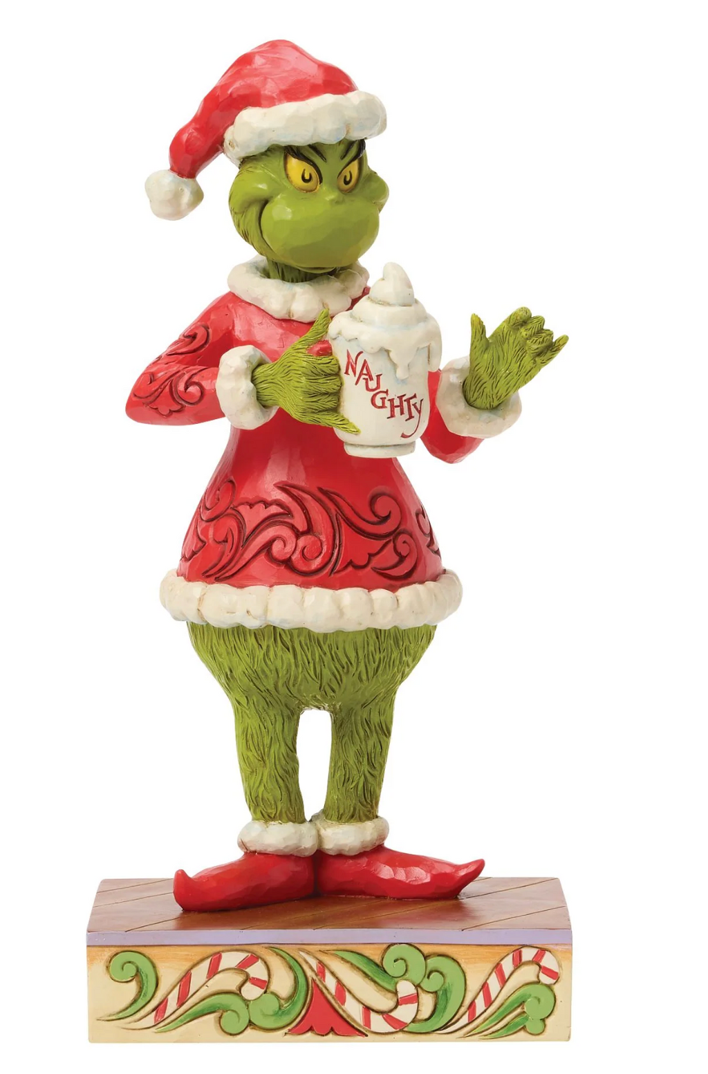 Figurine of a green character in a red outfit holding a mug with 'Naughty' on a white background