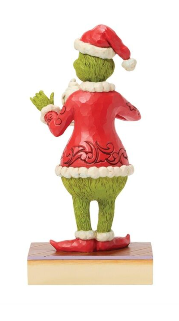Figurine of a character in a red outfit and Santa hat on a white background