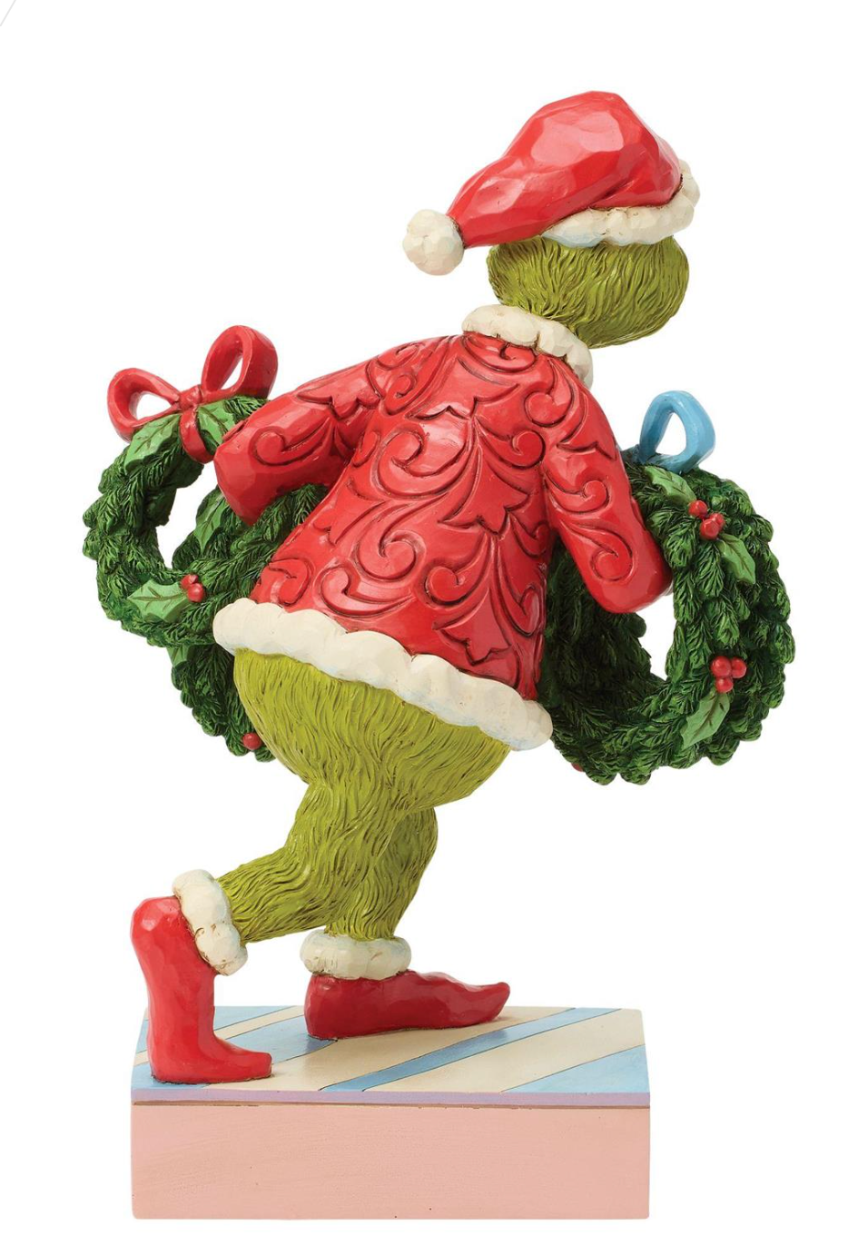 Grinch figurine holding a wreath on a white background