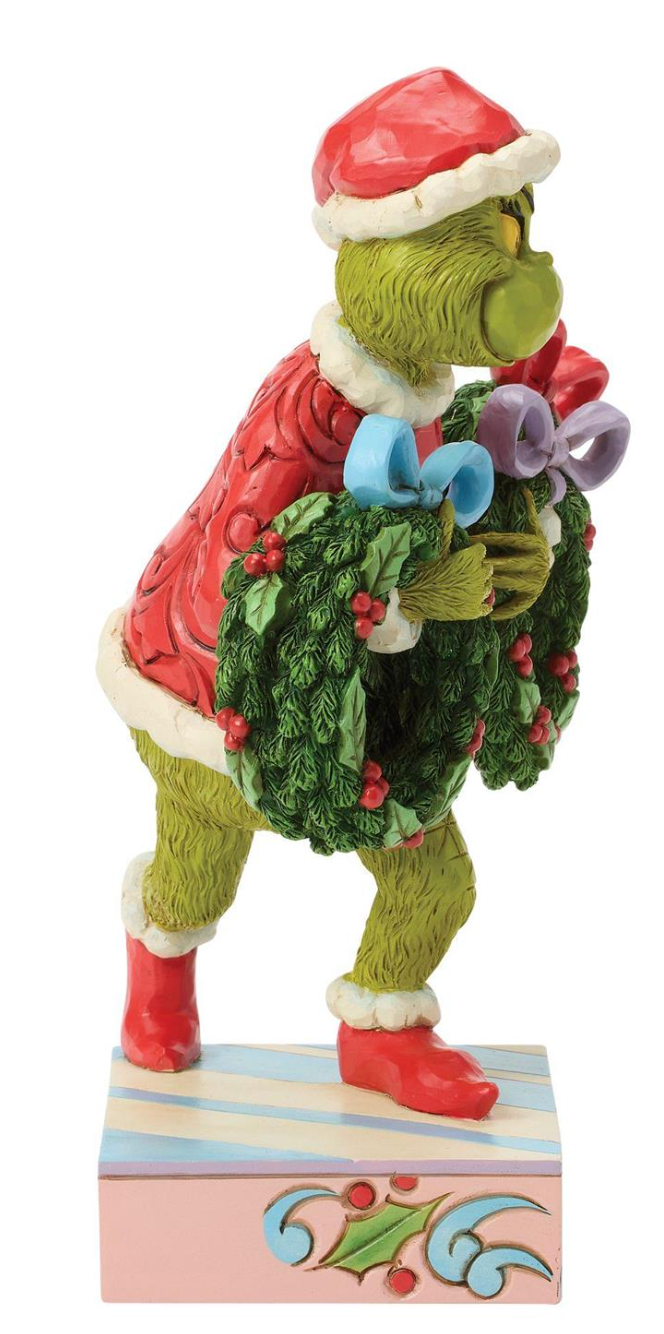 Colorful figurine of a character holding a wreath on a white background