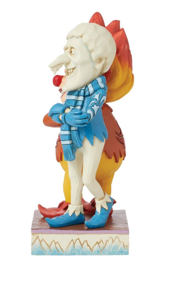 Colorful figurine of a character with a blue outfit and red hair on a white background