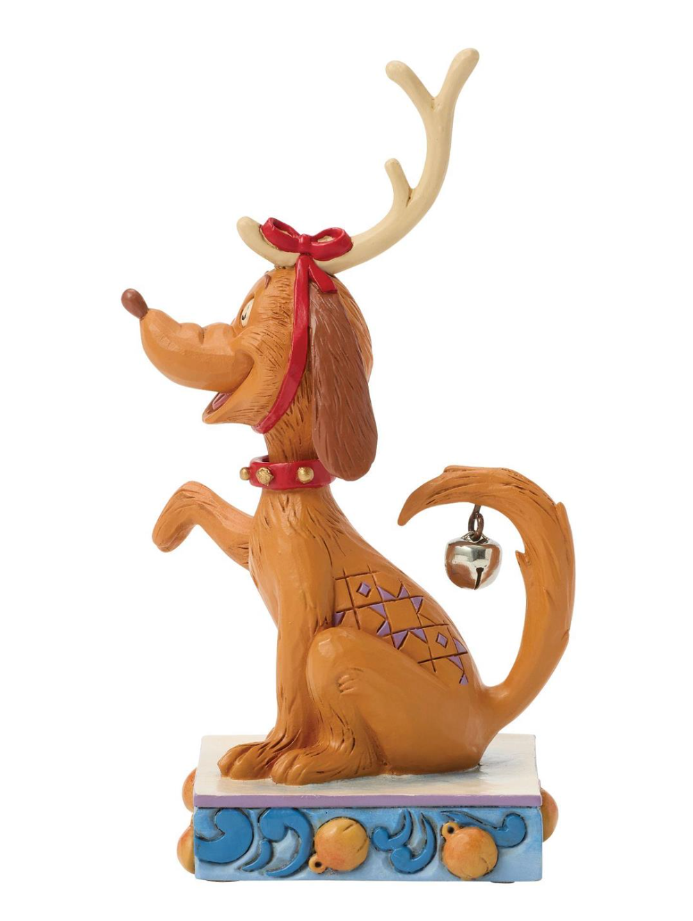 Dog figurine with reindeer antlers and a red bow on a white background